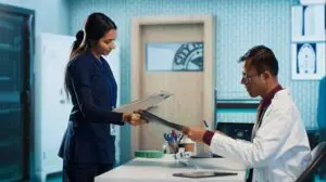 Doctor and nurse reviewing medical files together.